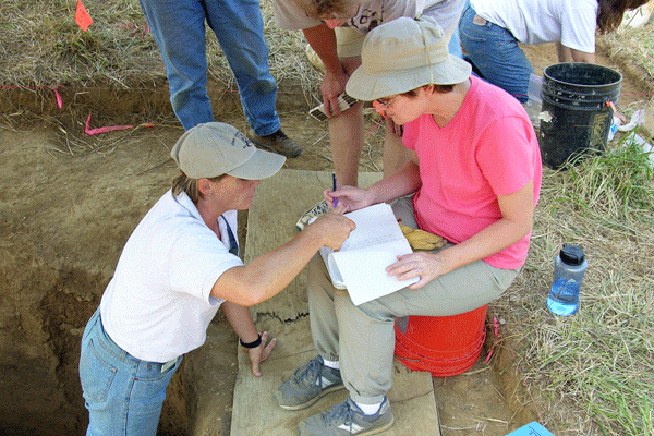 Belinda consults with Jane Cox about unit paperwork.