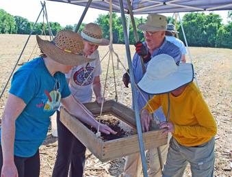 Claude works with volunteers at the screen in 2019