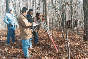 CAT members use a transit to measure distances and elevations.