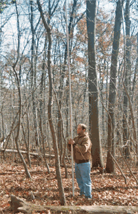 CAT member holds the stadia rod used to map a site.