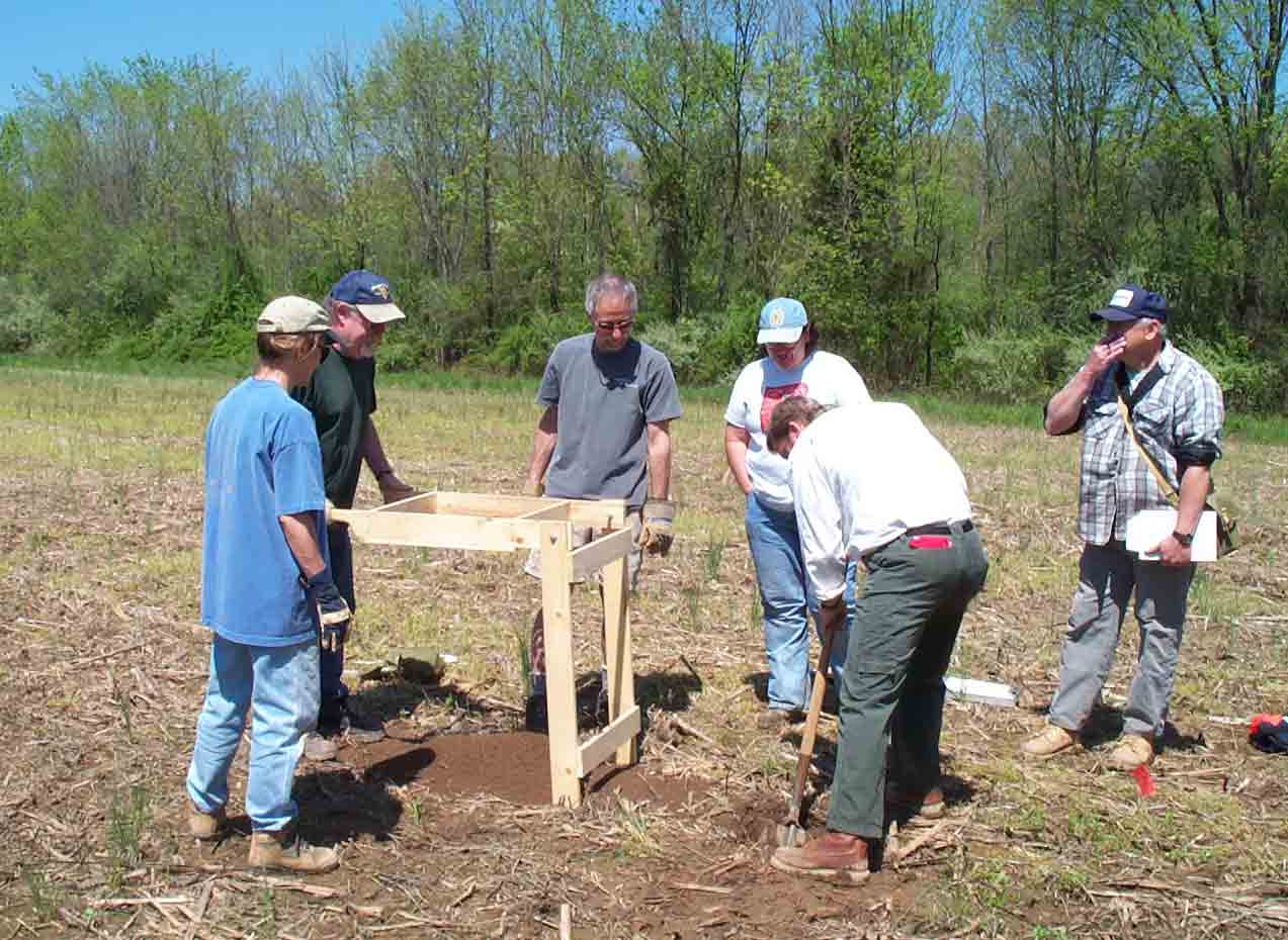 The crew learns how to dig the test pit and document results.